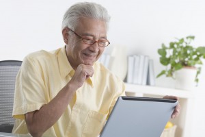 Senior Man Using Laptop --- Image by © Royalty-Free/Corbis